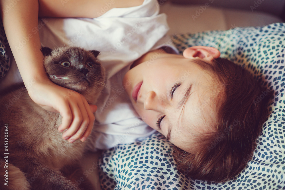 Cute boy and cat lying in the bed at morning. Child and his cat at home. Cute boy and cat lying in the bed at morning. Child and his cat at home.