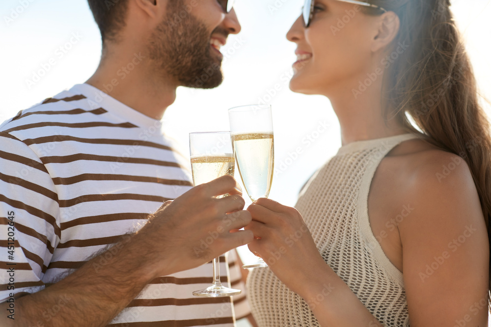 leisure, relationships and people concept - happy couple in sunglasses drinking champagne on summer beach leisure, relationships and people concept - happy couple in sunglasses drinking champagne on summer beach