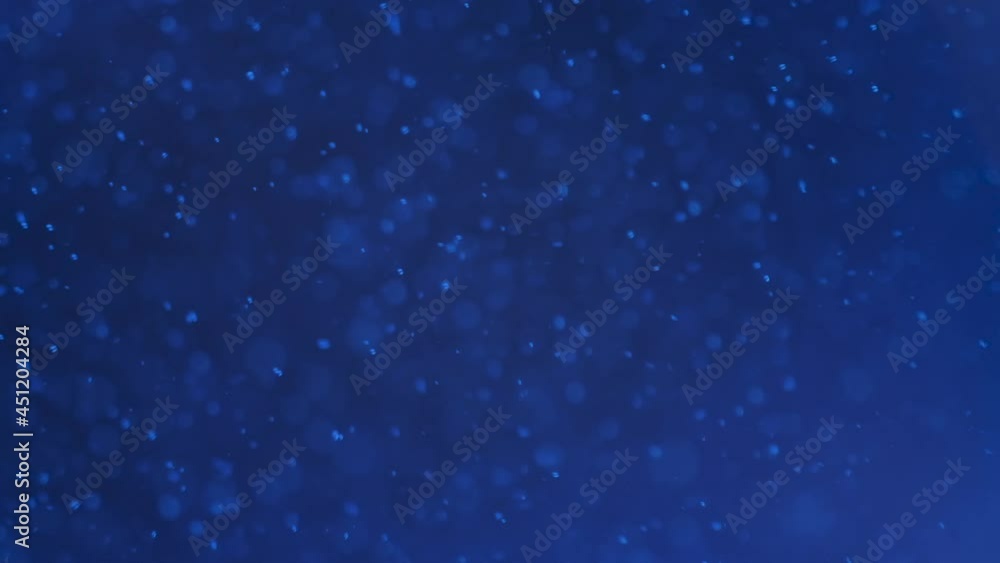 Slow motion. Large air bubble rises from the depths to the surface of the blue water. Background from large bubbles. Slow motion. Large air bubble rises from the depths to the surface of the blue water. Background from large bubbles.