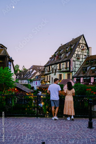 Colmar, Alsace, France. Petite Venice, water canal, and traditional half timbered houses. Colmar is a charming town in Alsace, France. couple man and women walking at the street during vacation