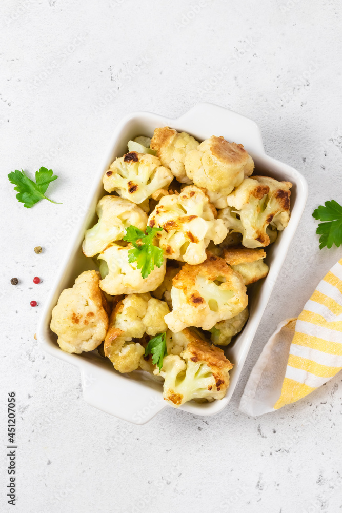 Spicy cauliflower wings in baking dish. Space for text, top view. Spicy cauliflower wings in baking dish. Space for text, top view.