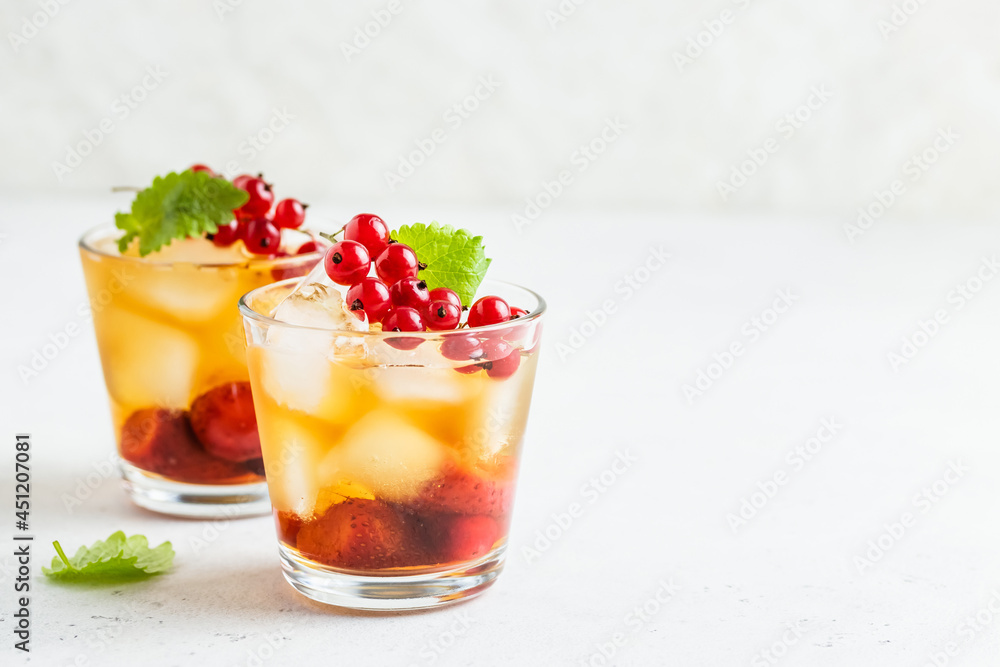 Kombucha mocktail, summer party drink, berry iced tea in glasses. Space fot text. Kombucha mocktail, summer party drink, berry iced tea in glasses. Space fot text.