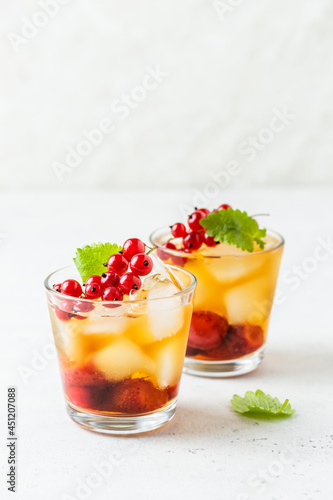 Kombucha mocktail, summer party drink, berry iced tea in glasses. Space fot text.
