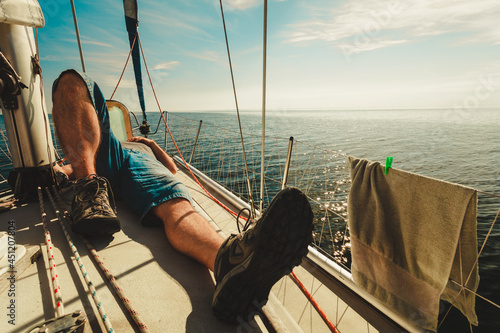 Man relaxing on sport yacht front © Voyagerix