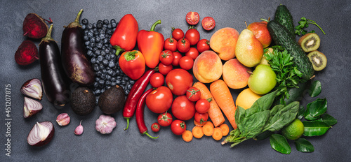 Fototapeta Naklejka Na Ścianę i Meble -  Assortment of rainbow colored vegetables, fruits and berries on dark background. Healthy vegan food set. Top view copy space