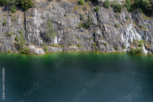 The green lake in the marble quarry with crystal clear water. Rocky mountain landscape. 