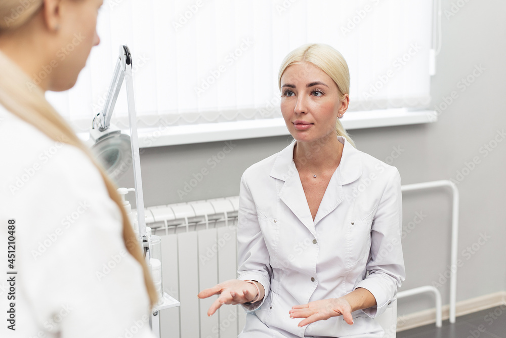 The beautician advises the client on cosmetics suitable for her skin type. Two women in the wellness salon. Consultation with a cosmetologist The beautician advises the client on cosmetics suitable for her skin type. Two women in the wellness salon. Consultation with a cosmetologist