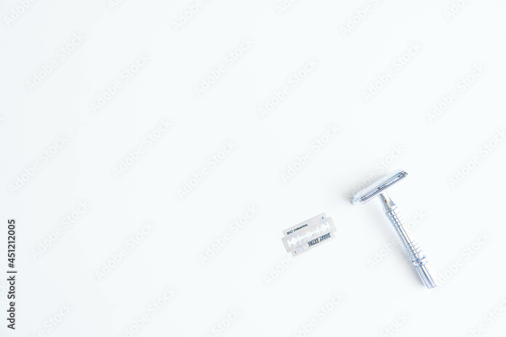 Vintage safety metal razor on a white background. Close-up. Isolated on white background. Reusable blade, zero waste product