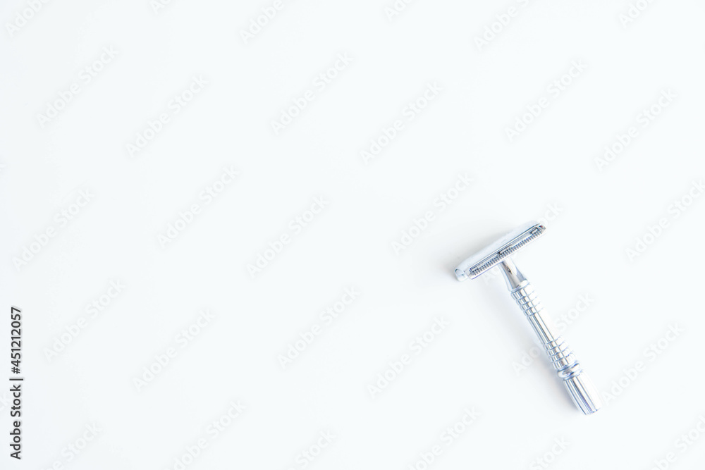 Vintage safety metal razor on a white background. Close-up. Isolated on white background. Reusable blade, zero waste product
