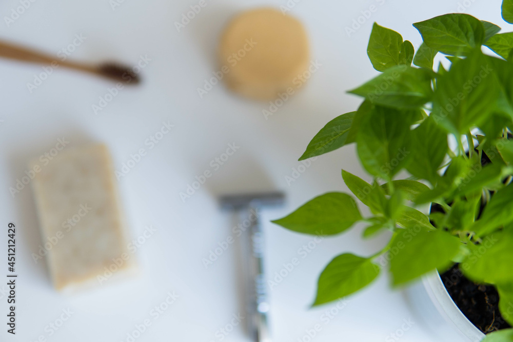 Zero waste product, close up caption. Bamboo toothbrush, solid shampoo, metal razor and solid hand soap. Sustainable bathroom products on a white background.