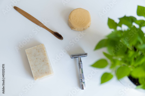 Obraz na płótnie Zero waste product, close up caption. Bamboo toothbrush, solid shampoo, metal razor and solid hand soap. Sustainable bathroom products on a white background. w salonie