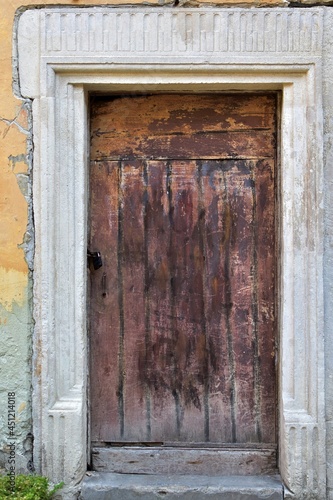 Basement entrance door in the wall of an old town house