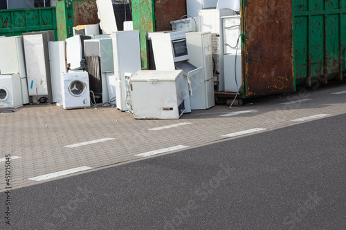 Old electrical appliances, washing machines in container. ELECTRONIC WASTE.