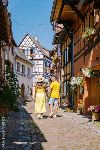 Eguisheim, Alsace, France, Traditional colorful halt-timbered houses in Eguisheim Old Town on Alsace Wine Route, France.colorful streets old town, couple man and woman on vacation inf France Elzas photo