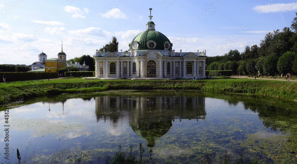 Picturesque Grotto Pavilion and its water reflection in swamped pond in Kuskovo manor park in Moscow.