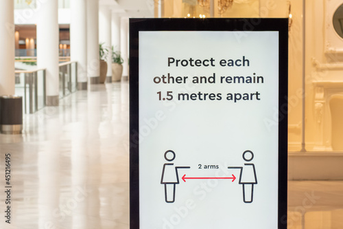 Social distancing information at the shoppin centre. Protect each other and remain 1.5 metres apart photo
