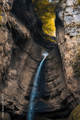 On a magical autumn day, a waterfall poured down in the middle of the gorge