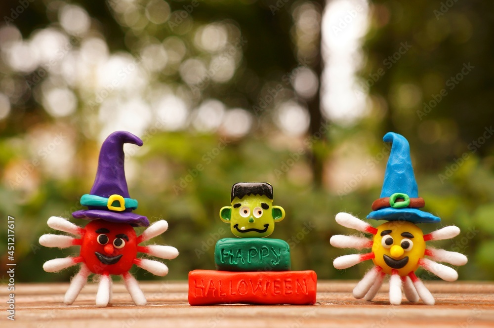 A figurine of a virus made of plasticine in a festive hat. The concept of Halloween. Close-up.
