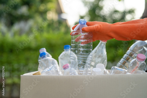 Wallpaper Mural Asian woman volunteer carry water plastic bottles into garbage box trash in park, recycle waste environment ecology concept. Torontodigital.ca