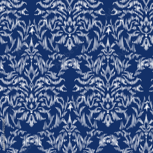 Seamless pattern - Tribal Art Ikat in traditional classic blue and white colors. Damascus - in Syrian Flower Pattern. Boho style. Printing on fabric. Ornamental plant pattern imitating weaving embroid