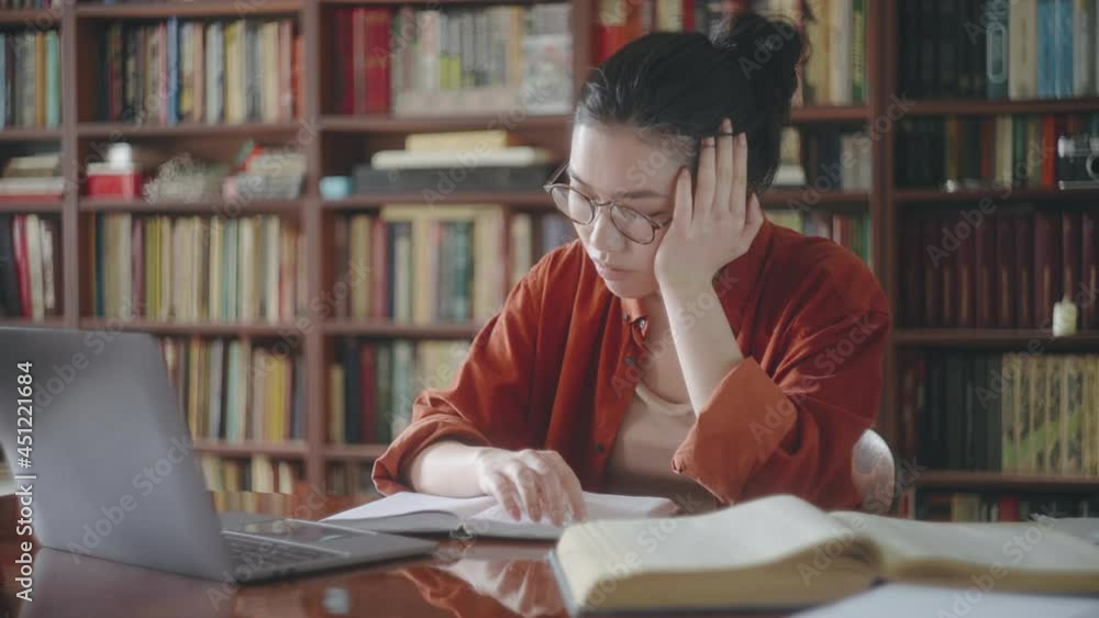 Sleepy tired asian student making notes from online course, distance education Sleepy tired asian student making notes from online course, distance education