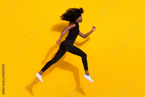 Full length body size side profile photo curly girl jumping up running on sale isolated vivid yellow color background