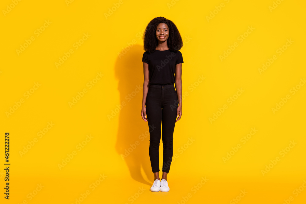 Full length body size photo curly girl wearing casual clothes smiling isolated vibrant yellow color background Full length body size photo curly girl wearing casual clothes smiling isolated vibrant yellow color background