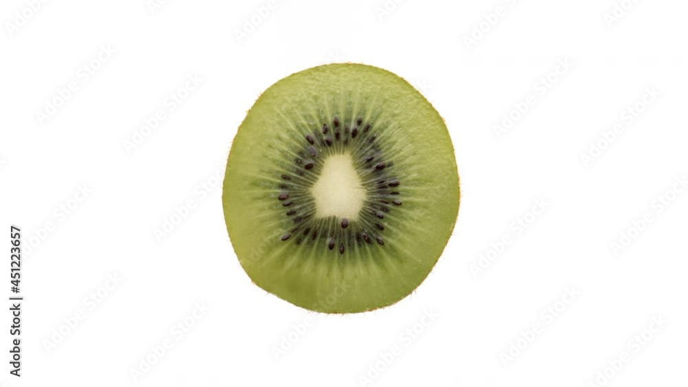 Top view of kiwi fruit cross cut rotating on white background. Top view of kiwi fruit cross cut rotating on white background.