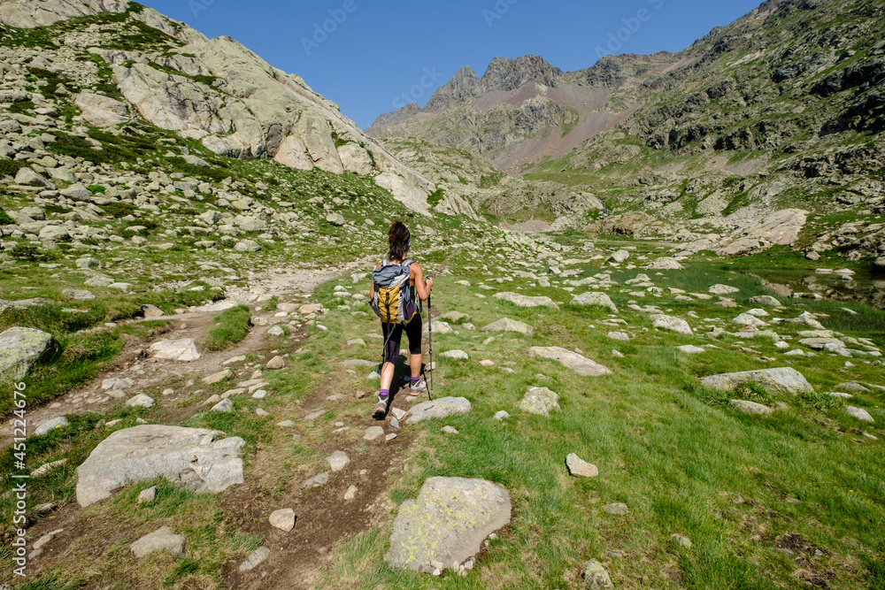 hiker on Ibones azules and Bachimaña alto route, Huesca province, Spain