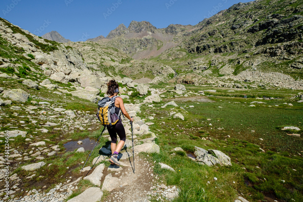 hiker on Ibones azules and Bachimaña alto route, Huesca province, Spain