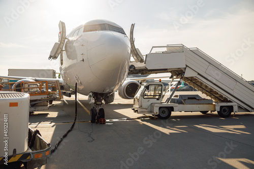 Details of modern airplane during refueling at airport outdoors on a daytime. Aircraft. Plane, shipping, transportation concept