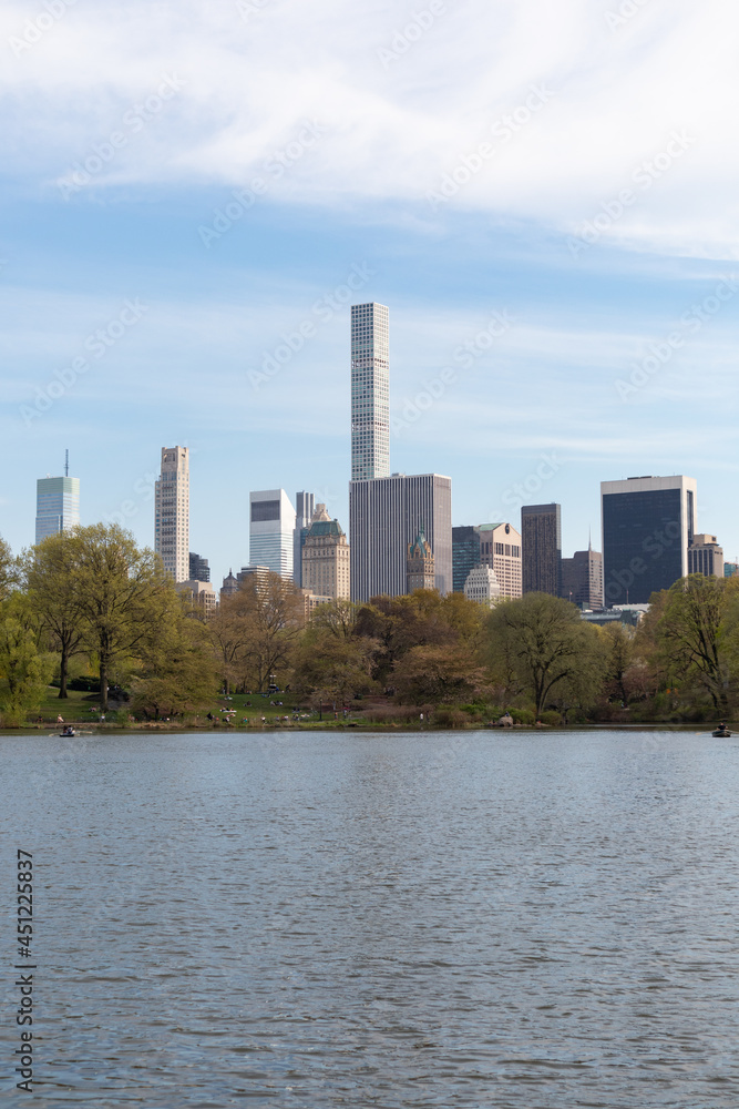 Springtime Midtown Manhattan Skyline seen from the Lake at Central Park in New York City Springtime Midtown Manhattan Skyline seen from the Lake at Central Park in New York City