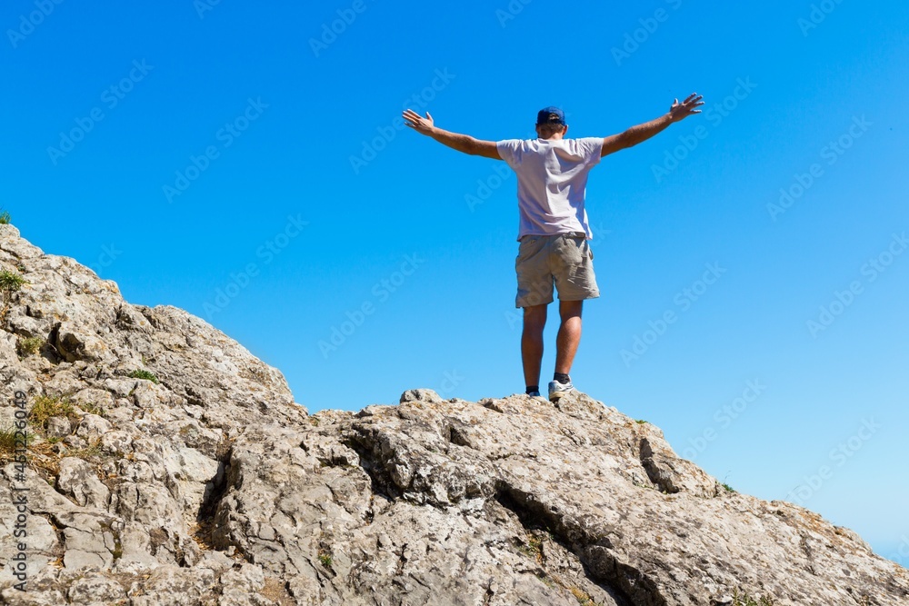 Man Celebrating on Mountain Top