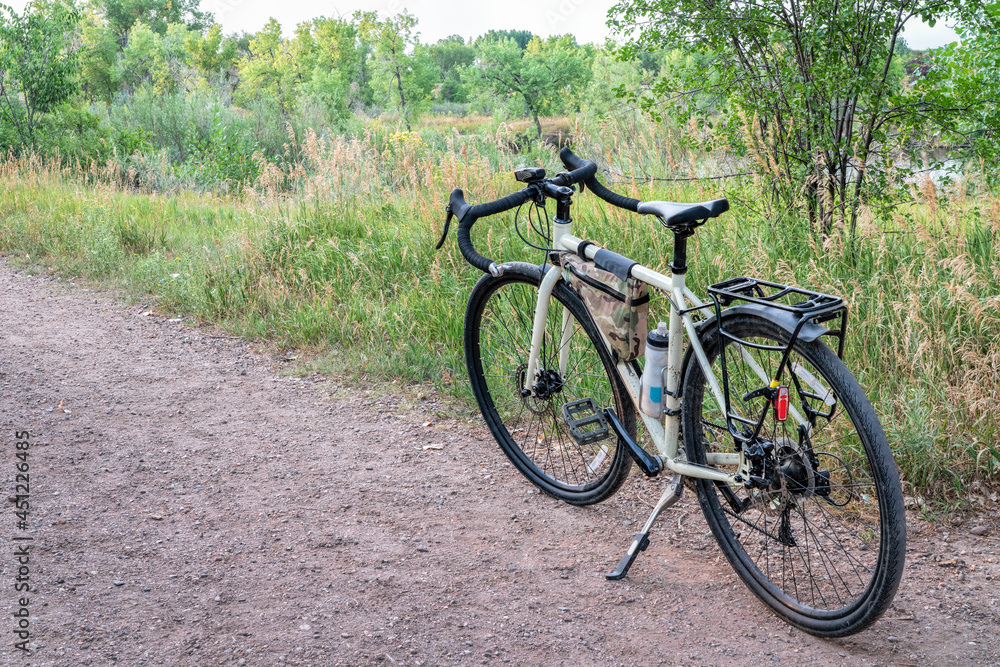 touring bicycle on a gravel trail in one of Fort Collins natural areas along the Poudre River in northern Colorado, summer scenery at dusk