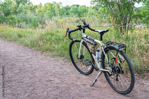 touring bicycle on a gravel trail in one of Fort Collins natural areas along the Poudre River in northern Colorado, summer scenery at dusk