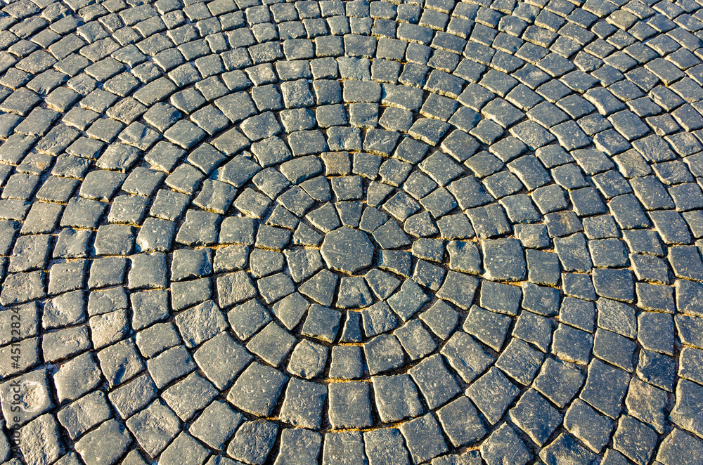 Cobblestones on the pavement laid in circles. Cobblestones on the pavement laid in circles.