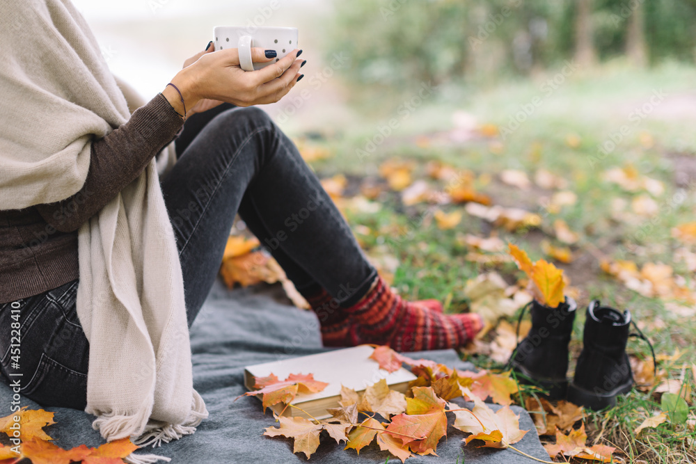 Woman in brown sweater, black jeans and 