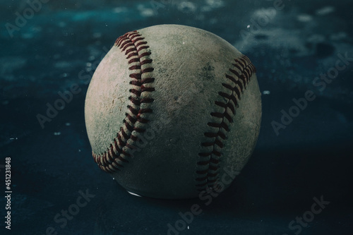 baseball on blue background closeup with shallow depth of field.