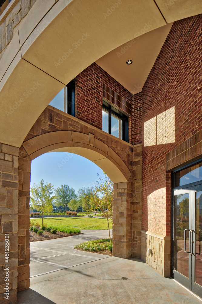 Stone arch entrance to brick office business building