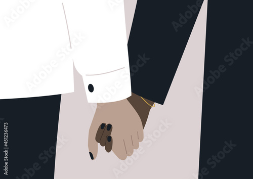 Interracial romance and friendship, a couple holding hands