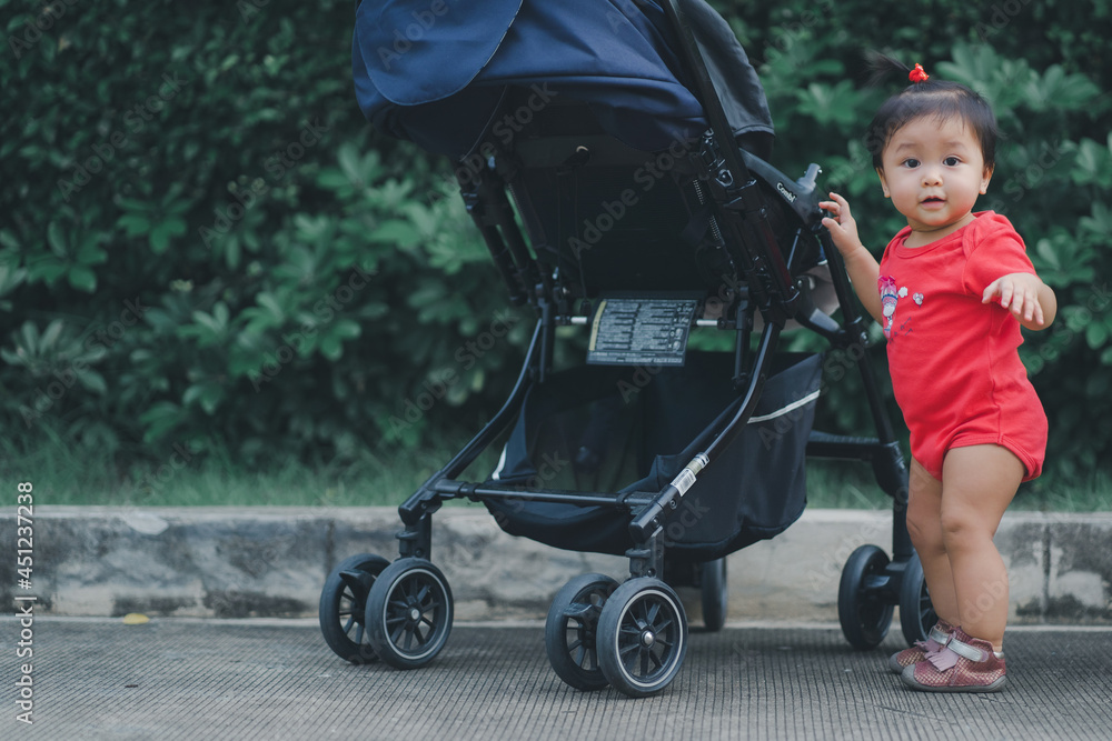 child standing by touch stroller for balance in development according to the age of the child with happy smile relax in evening time child standing by touch stroller for balance in development according to the age of the child with happy smile relax in evening time