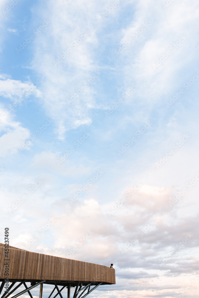Unrecognizable person on terrace against sunset sky Unrecognizable person on terrace against sunset sky