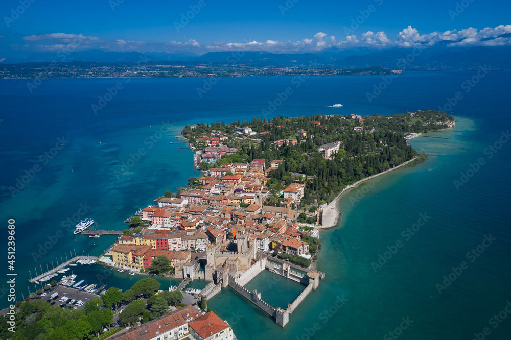 Panoramic view at high altitude.  Aerial view on Sirmione sul Garda. Italy, Lombardy. Rocca Scaligera Castle in Sirmione. View by Drone.