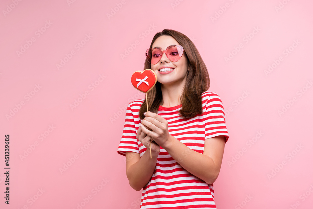 Photo of young excited girl happy positive smile look hungry sweet dessert cookies hear shape isolated over pink color background Photo of young excited girl happy positive smile look hungry sweet dessert cookies hear shape isolated over pink color background
