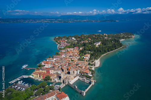 Panoramic view at high altitude. Aerial view on Sirmione sul Garda. Italy, Lombardy. Rocca Scaligera Castle in Sirmione. View by Drone.