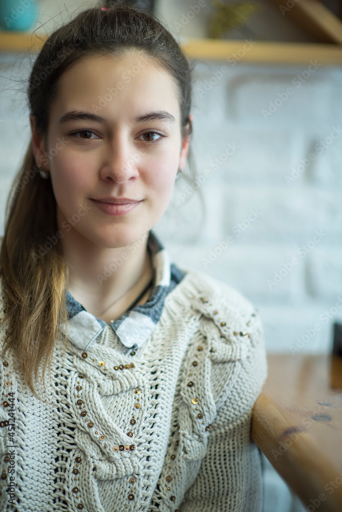 Young beautiful girl in a cafe, close-up.