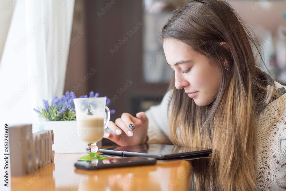 Young beautiful girl in a cafe, close-up. Young beautiful girl in a cafe, close-up.
