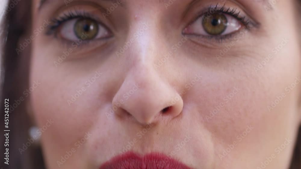 Young woman talking to camera as camera moves between her lips and eyes Young woman talking to camera as camera moves between her lips and eyes