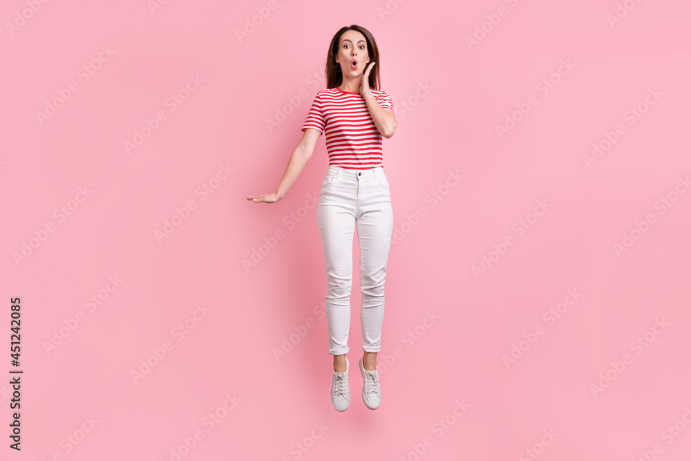 Full size photo of young girl amazed shocked jump show hand size measure isolated over pastel color background Full size photo of young girl amazed shocked jump show hand size measure isolated over pastel color background