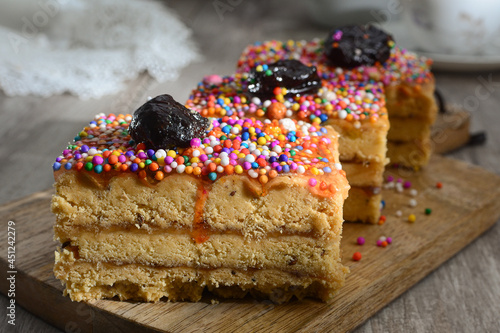 Tasty cake with nougat and prune on plate